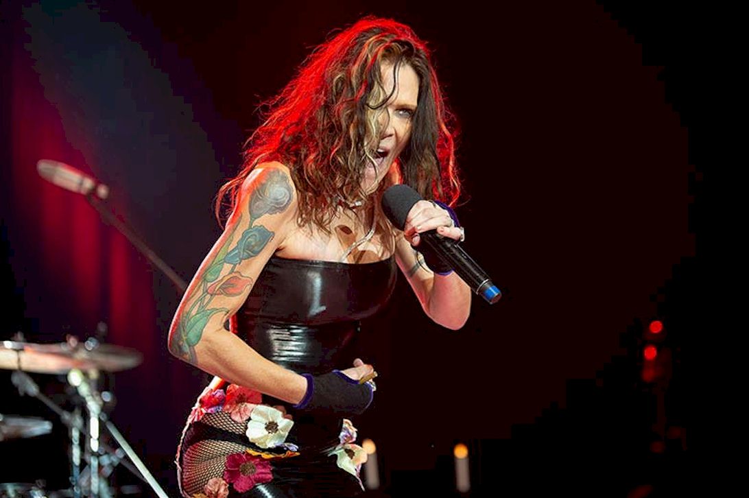 BETH HART 2026 UK dates - Photo Credit © Rocky Roode - female singer with microphone and tattoos on her upper arm