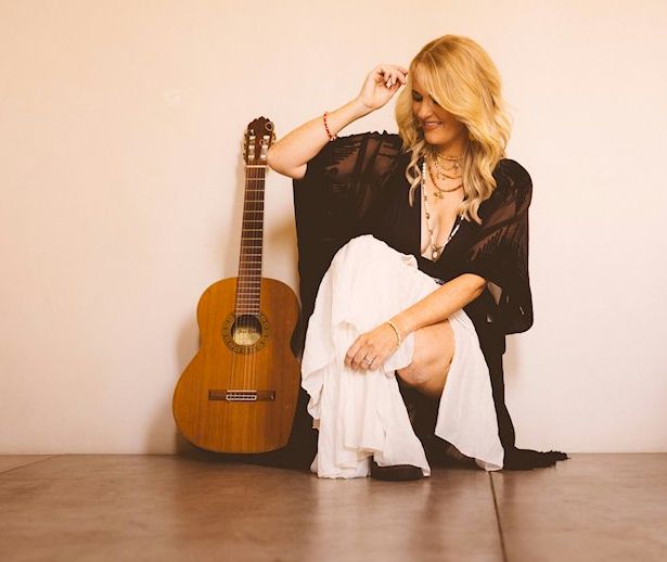 ELLES BAILEY Presents a Nurturing Narrative - photo © Rob Blackham - girl with red-amber hair and dark chiffon blouse knelt on floor with acoustic guitar by her side