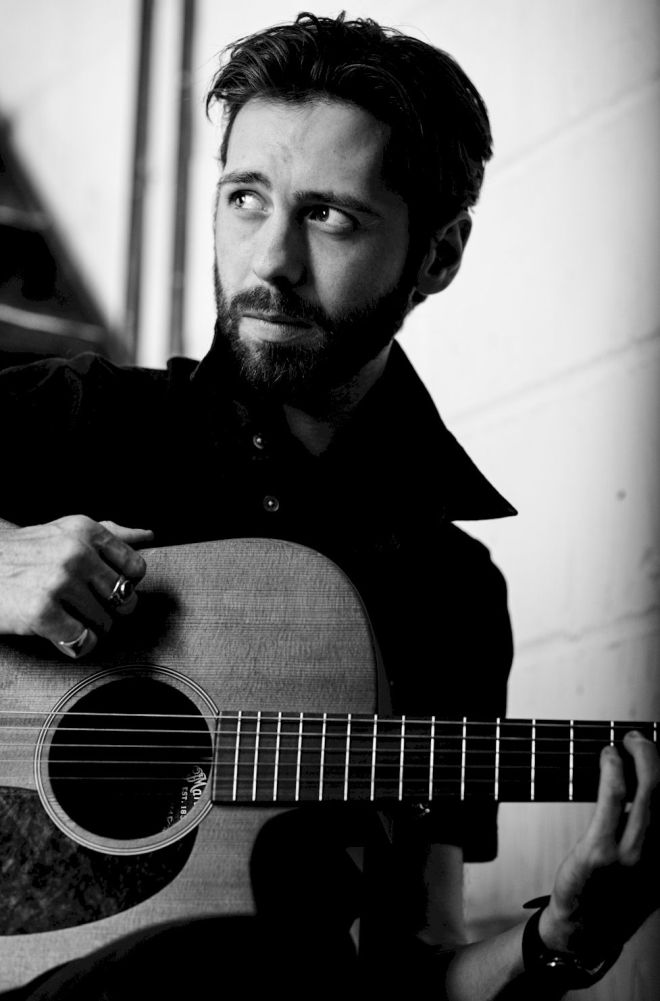 LAURENCE JONES On My Own photo credit Blackham Images - man with dark hair holding a guitar