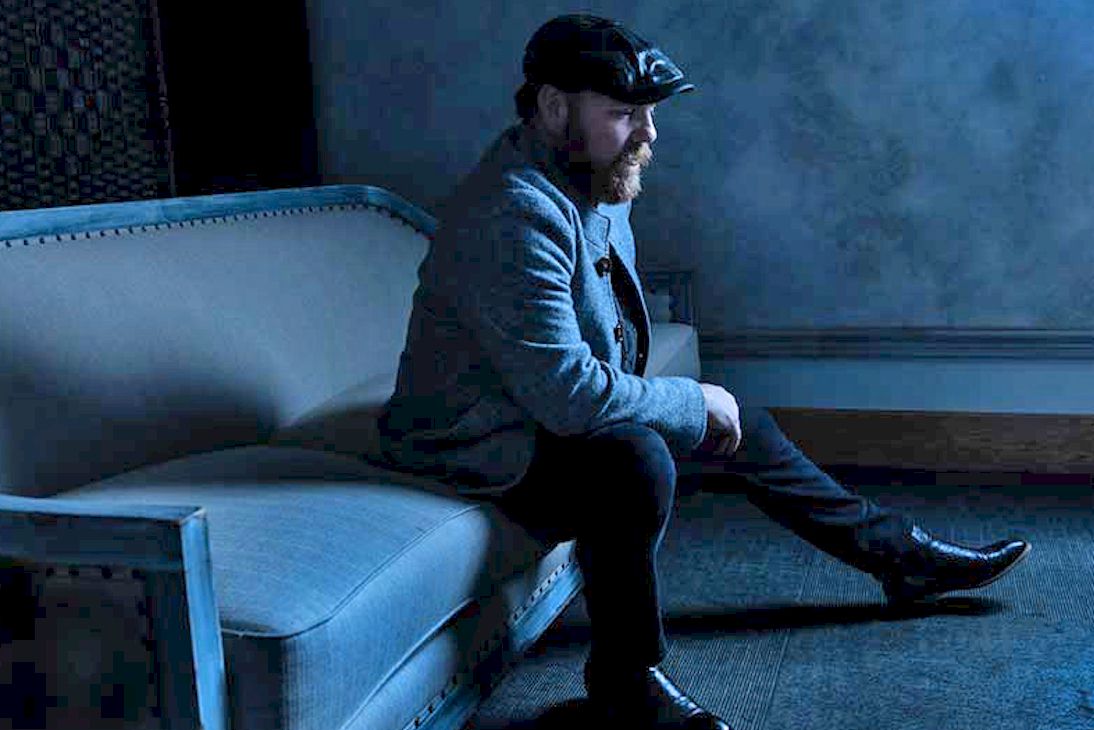 MARC BROUSSARD Chance Worth Taking - photo Jeff Fasano - bearded man in blue, seated on blue sofa