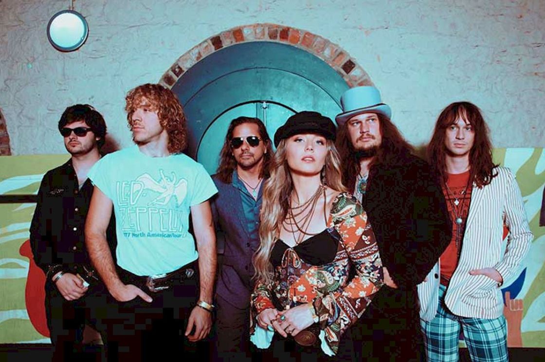 PARKER BARROW live UK dates - photo Adam Kennedy - one woman wearing a hat with five men, perhaps standing on a stage