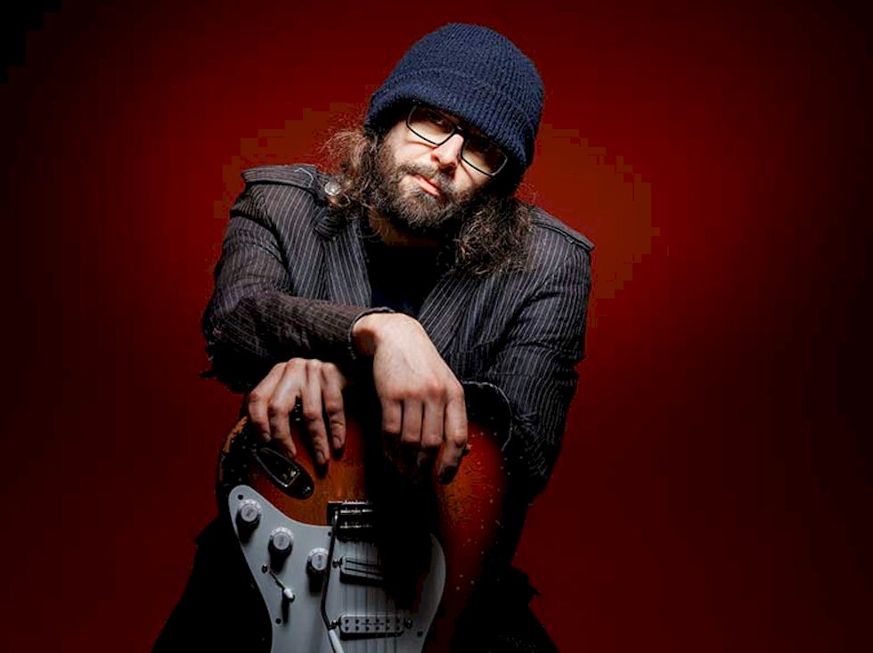 RED GIANT Can't Be Found - bearded man with guitar, wearing beanie hat and spectacles