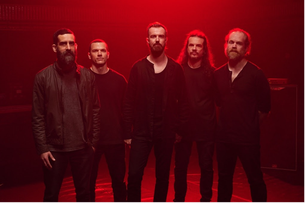 KARNIVOOL In Verses Tour Dates - five men wearing black against a red stage background - Photo credit Courtney McAllister