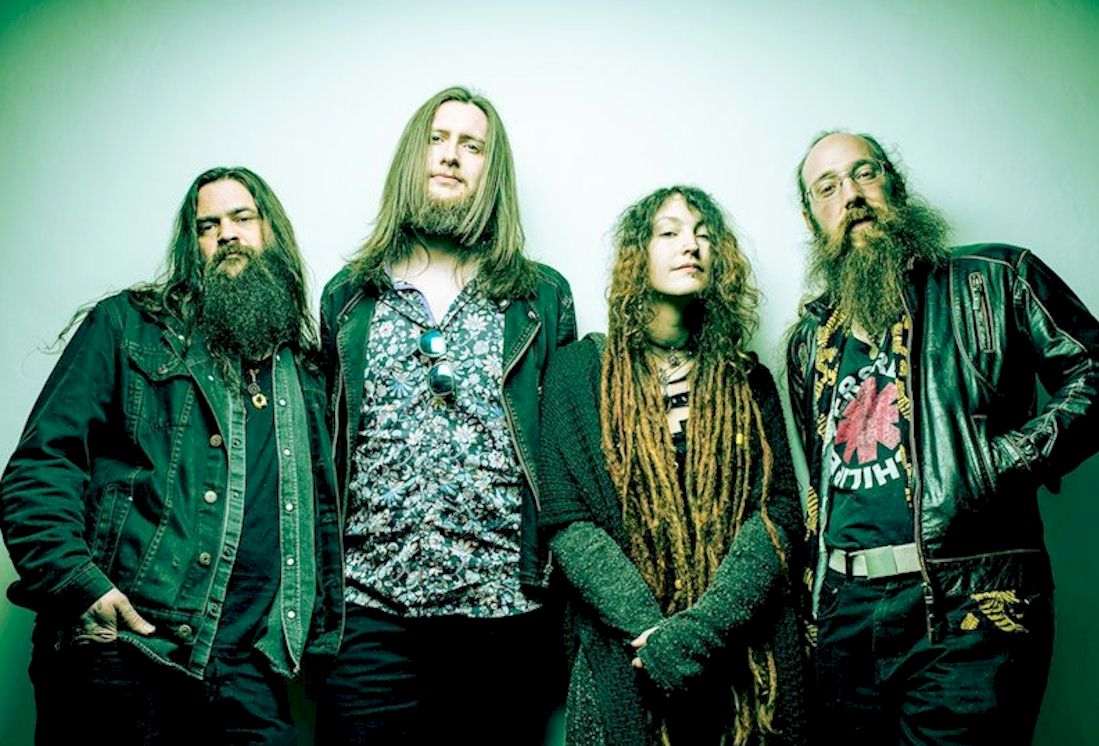 BEGGARS BLISS photo Jason Bridges - three men in motorcycle-style clothing with one woman who has dreadlocks and long gloves