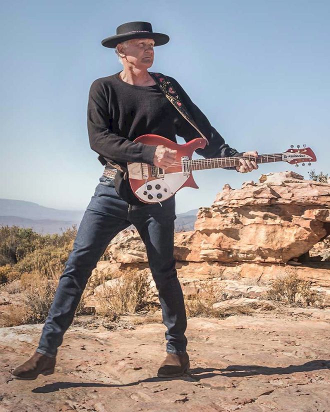 STEVE LOUW Traces of the Flood photo © Jacqui van Staden - man in hat holding guitar in rocky desert scene