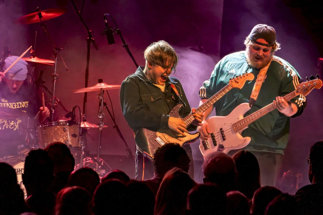 ZAC SCHULZE GANG Live at Shepherd's Bush Empire - photo credit Phil Honley - power trio on stage, with bass guitar, lead guitar, and drums