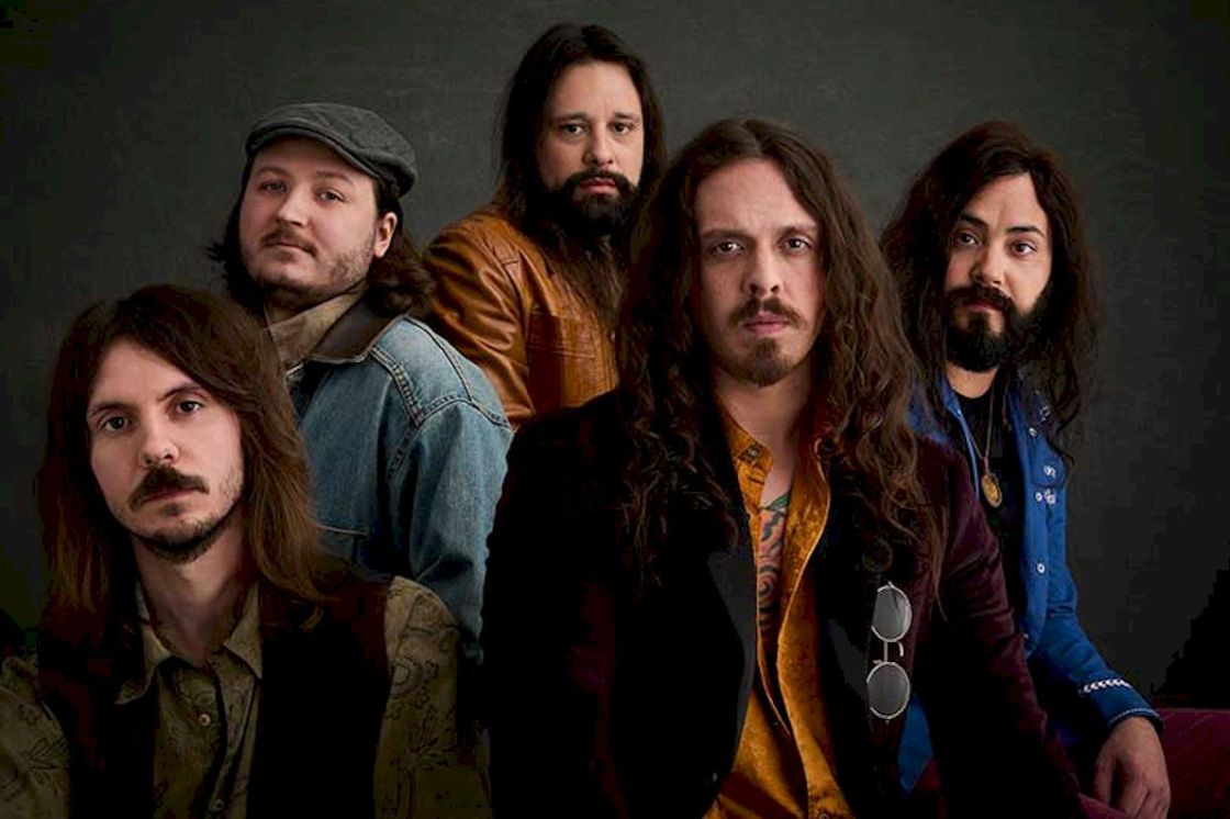 THE COMMONERS Runnin’ Blind Photo Credit © Paul Wright - five white men all with beards and mustaches seated