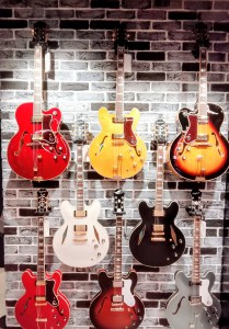 Gibson Garage London - photo Neil Mach - Gibson guitars presented against brick wall