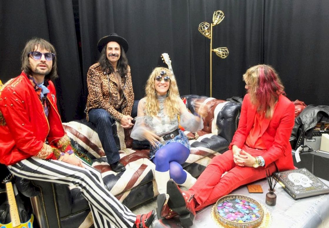THE DAMN TRUTH Gibson Garage London - photo Neil Mach - band members on leather sofa, one female three males in colourful stage clothing