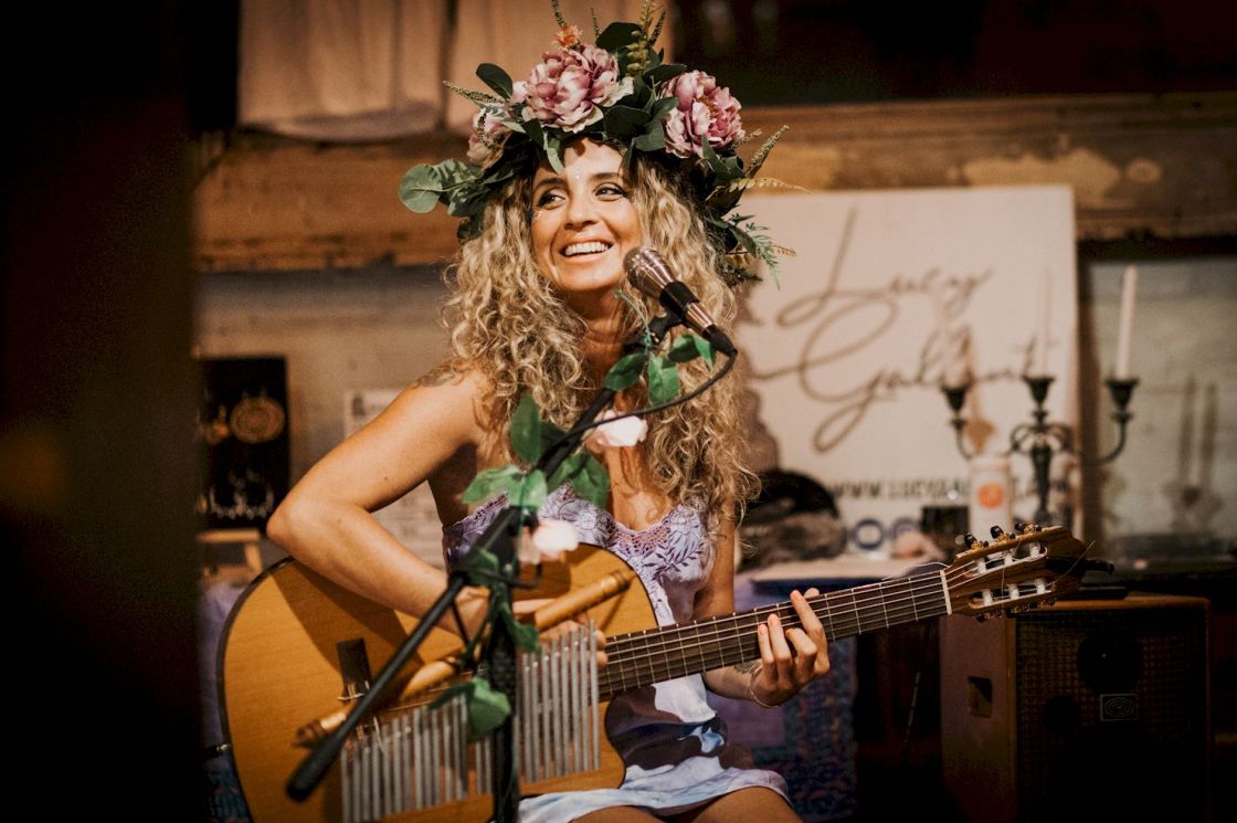 LUCY GALLANT Venom photo credit Brea Martin - girl singer with guitar. Girl has flowers in her hair