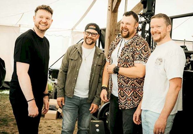 Wood Burnt Red - Photo Credit © Lucy Cave - four men at side of festival stage
