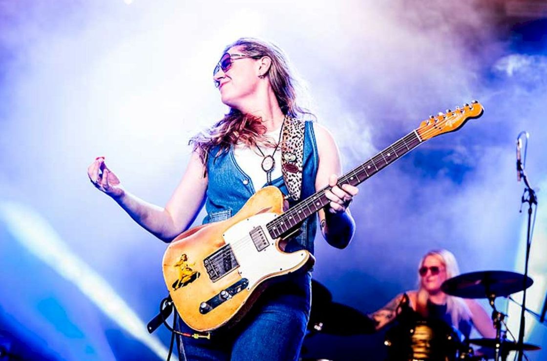 JOANNE SHAW TAYLOR Tour Dates Photo Credit © Marco van Rooijen - white girl dressed in blue denim holding golden guitar on stage