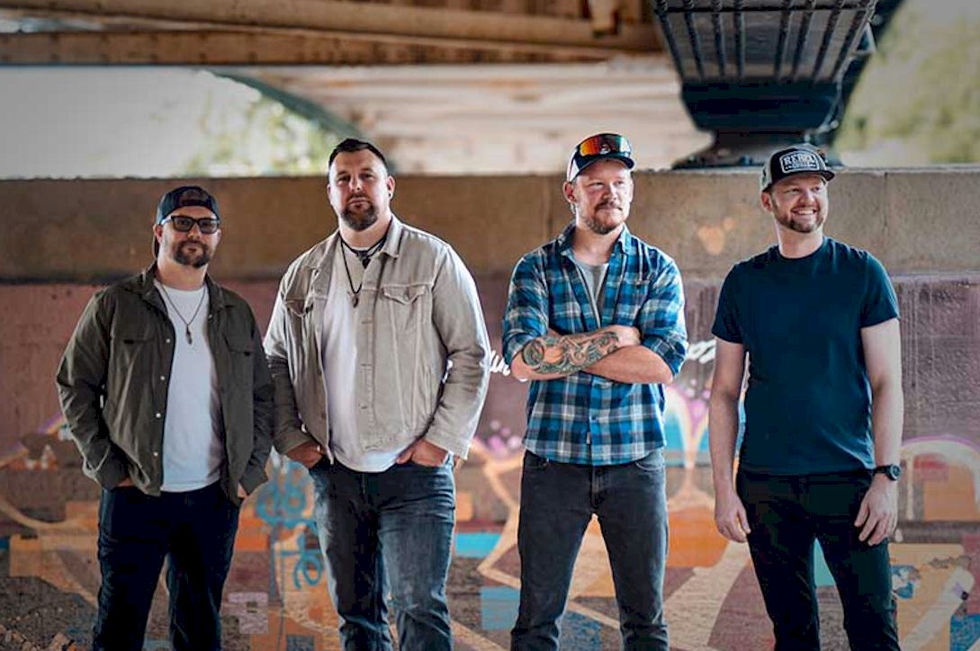 WOOD BURNT RED Count Blessings - Photo Credit © Lizzie Franklin - four white men standing under bridge arch. Three of the men wear baseball caps